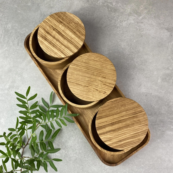 Set of three oak wood bowls on a tray