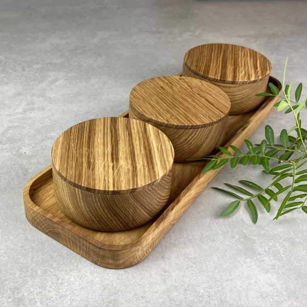 Set of three oak wood bowls on a tray